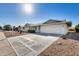 A charming single-story home features a spacious driveway and low maintenance desert landscaping at 13219 W Prospect Dr, Sun City West, AZ 85375