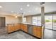 Open-plan kitchen with tile floors, neutral walls and stainless steel dishwasher and sink at 13219 W Prospect Dr, Sun City West, AZ 85375