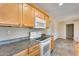 A close up on white kitchen appliances and honey-colored cabinets for a cozy and inviting feel at 13219 W Prospect Dr, Sun City West, AZ 85375