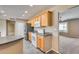 Well-lit kitchen showcasing wood cabinets, stainless steel refrigerator, and modern white appliances at 13219 W Prospect Dr, Sun City West, AZ 85375