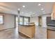 Bright, airy kitchen and adjacent dining area with tile flooring, recessed lighting, and a breakfast bar at 13219 W Prospect Dr, Sun City West, AZ 85375