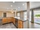 Inviting kitchen boasts stainless steel appliances and a breakfast bar with a view to the outdoor patio at 13219 W Prospect Dr, Sun City West, AZ 85375