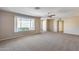 Spacious living room featuring neutral walls and carpet with a view to the front yard at 13219 W Prospect Dr, Sun City West, AZ 85375