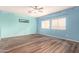 Main bedroom with light blue walls and wood floors at 13257 W Watson Ln, Surprise, AZ 85379