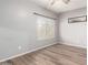 Bedroom with wood-look floors and large window at 13257 W Watson Ln, Surprise, AZ 85379