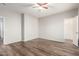 Empty bedroom with wood-look floors at 13257 W Watson Ln, Surprise, AZ 85379