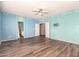 Bright bedroom with wood-look floors and ceiling fan at 13257 W Watson Ln, Surprise, AZ 85379