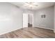 Bright bedroom featuring wood-look floors and ceiling fan at 13257 W Watson Ln, Surprise, AZ 85379