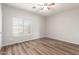 Simple bedroom with wood-look floors and window at 13257 W Watson Ln, Surprise, AZ 85379