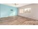 Bedroom with light walls, wood-look floors, and a ceiling fan at 13257 W Watson Ln, Surprise, AZ 85379