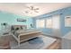 Virtually staged main bedroom with light blue walls at 13257 W Watson Ln, Surprise, AZ 85379