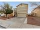 Two-story house with a beige exterior, stone accents, and a two-car garage at 13257 W Watson Ln, Surprise, AZ 85379