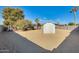 Sandy backyard with shed and play equipment at 1437 W Yukon Dr, Phoenix, AZ 85027