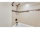 Bathroom with tub shower and mosaic tile detail at 1437 W Yukon Dr, Phoenix, AZ 85027