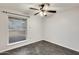 Well-lit bedroom with herringbone floors and ceiling fan at 1437 W Yukon Dr, Phoenix, AZ 85027