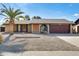 Single-story home with a red door and desert landscaping at 1437 W Yukon Dr, Phoenix, AZ 85027