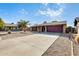 Single story home with a two-car garage and gravel driveway at 1437 W Yukon Dr, Phoenix, AZ 85027