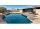 Inviting backyard oasis with a sparkling pool and waterfall feature at 1437 W Yukon Dr, Phoenix, AZ 85027