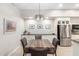 Bright dining area with wood table and chairs, adjacent to the kitchen at 16333 E Lombard Pl, Fountain Hills, AZ 85268