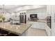 Granite kitchen island with sink and breakfast bar seating at 16333 E Lombard Pl, Fountain Hills, AZ 85268