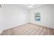 Well-lit bedroom featuring a window and carpet flooring at 1702 E Bell Rd # 130, Phoenix, AZ 85022