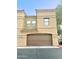 Tan two-story building with brown garage door at 1702 E Bell Rd # 130, Phoenix, AZ 85022