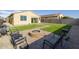 Artificial turf backyard with fire pit and built-in BBQ at 17669 W Daley Ln, Surprise, AZ 85387