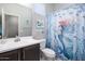 Charming bathroom with mermaid-themed shower curtain and dark brown vanity at 17669 W Daley Ln, Surprise, AZ 85387