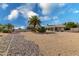 Large backyard with a rock pathway and palm trees at 18003 N 136Th Way, Sun City West, AZ 85375