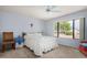 Bedroom with a queen-size bed, ceiling fan and view of backyard at 18003 N 136Th Way, Sun City West, AZ 85375