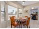 Cozy breakfast nook with a round table and chairs, near the kitchen at 18003 N 136Th Way, Sun City West, AZ 85375