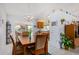 Spacious dining area with a wooden table and chairs, kitchen view at 18003 N 136Th Way, Sun City West, AZ 85375