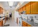 View of kitchen with appliances, wood cabinets and granite counters at 18003 N 136Th Way, Sun City West, AZ 85375