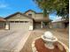 Two-story house with a landscaped yard and a water fountain at 2028 E Lipizzan Dr, San Tan Valley, AZ 85140