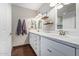 Elegant bathroom with double vanity, quartz countertops, and dark wood flooring at 2032 E Pegasus Dr, Tempe, AZ 85283