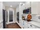 Modern kitchen with white cabinets, stainless steel appliances, and quartz countertops at 2032 E Pegasus Dr, Tempe, AZ 85283