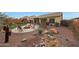 Landscaped backyard oasis with fire pit and seating area at 20587 N 259Th Dr, Buckeye, AZ 85396