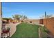 Landscaped backyard with grassy area and fire pit at 20587 N 259Th Dr, Buckeye, AZ 85396