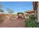 Landscaped backyard with pergola, seating area, and water feature at 20587 N 259Th Dr, Buckeye, AZ 85396