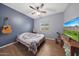 Bedroom with guitar, TV, and wood floors at 20587 N 259Th Dr, Buckeye, AZ 85396