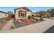 Single-story home with desert landscaping and a large driveway at 20587 N 259Th Dr, Buckeye, AZ 85396