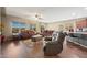 Bright living room featuring hardwood floors, leather sofas, and a view of the kitchen at 20587 N 259Th Dr, Buckeye, AZ 85396