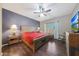 Spacious main bedroom with wood flooring and ceiling fan at 20587 N 259Th Dr, Buckeye, AZ 85396