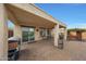 Covered patio with brick pavers and seating area at 20587 N 259Th Dr, Buckeye, AZ 85396