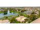 Aerial view of a beautiful home near a lake, lush greenery, and meticulously maintained landscaping at 21 E Oakwood Hills Dr, Chandler, AZ 85248