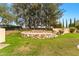 Backyard stage area with a stone surround and seating, surrounded by mature trees at 21 E Oakwood Hills Dr, Chandler, AZ 85248