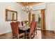 Traditional dining room featuring hardwood floors, a decorative chandelier, and seating for six at 21 E Oakwood Hills Dr, Chandler, AZ 85248