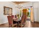 Traditional dining room featuring hardwood floors, a decorative chandelier, and french door access to outdoors at 21 E Oakwood Hills Dr, Chandler, AZ 85248