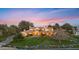 Stunning exterior view of a luxury home at dusk with a stream and manicured lawn at 21 E Oakwood Hills Dr, Chandler, AZ 85248