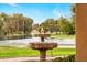 Charming outdoor fountain surrounded by lush greenery and a serene lake backdrop, creating a tranquil setting at 21 E Oakwood Hills Dr, Chandler, AZ 85248